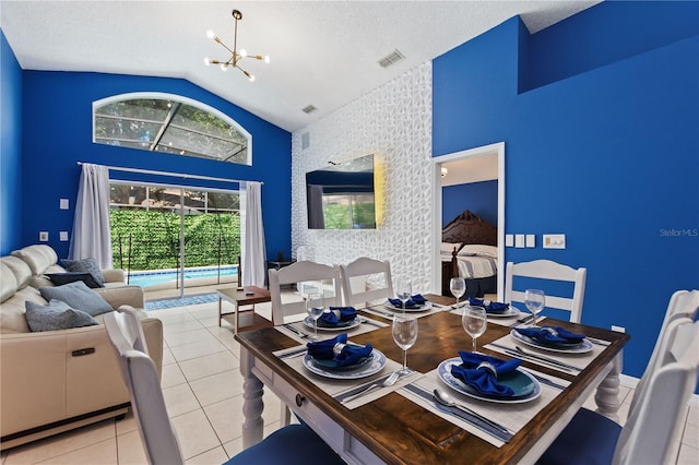 dining room with visible vents, an accent wall, tile patterned flooring, a textured ceiling, and a notable chandelier