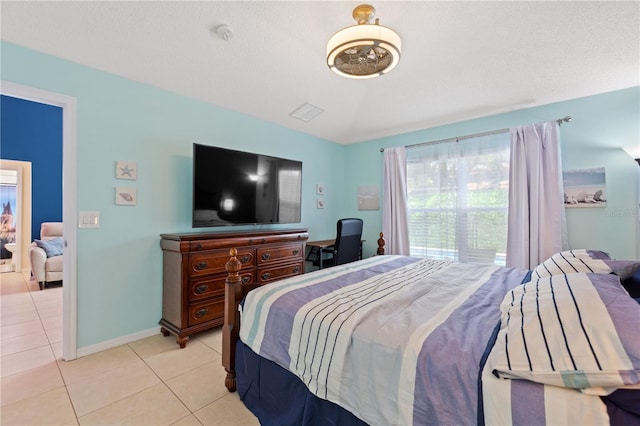 bedroom with light tile patterned floors, visible vents, and baseboards