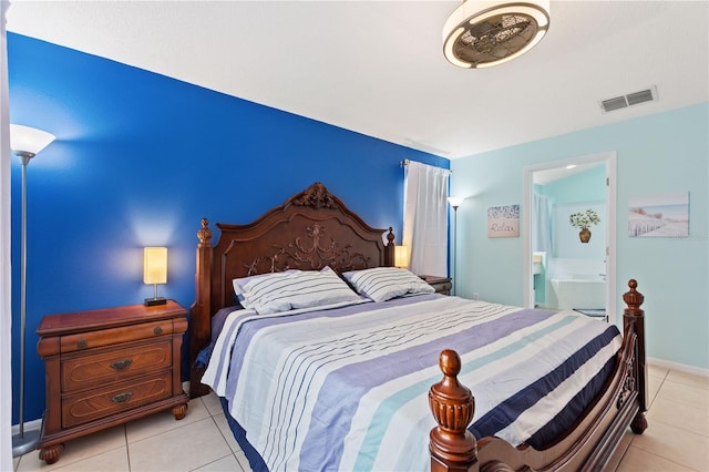 bedroom with light tile patterned floors, connected bathroom, visible vents, and baseboards