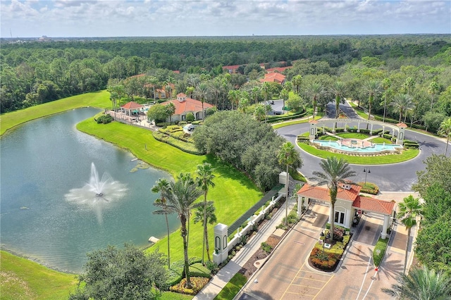 drone / aerial view featuring a water view and a view of trees