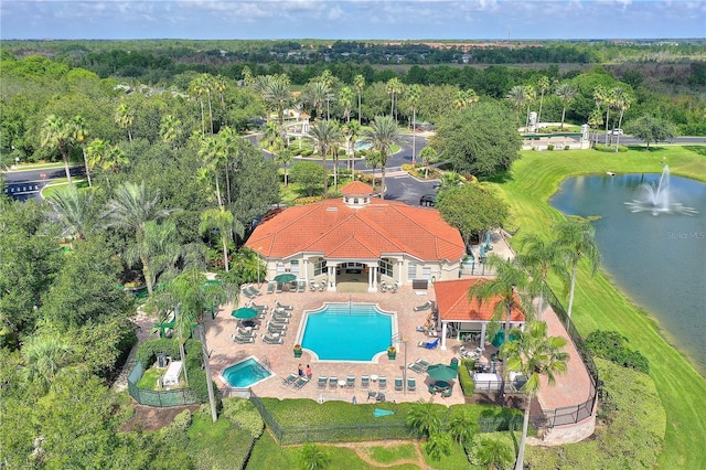 birds eye view of property with a water view and a view of trees