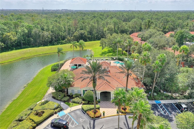 aerial view with a water view and a wooded view