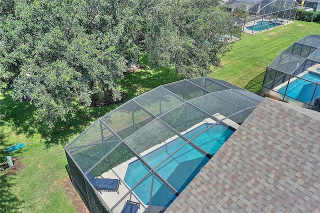 pool with a lawn and a lanai