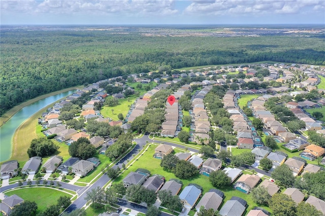 birds eye view of property with a water view, a residential view, and a view of trees