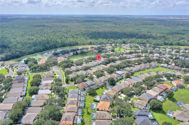 bird's eye view with a forest view, a water view, and a residential view