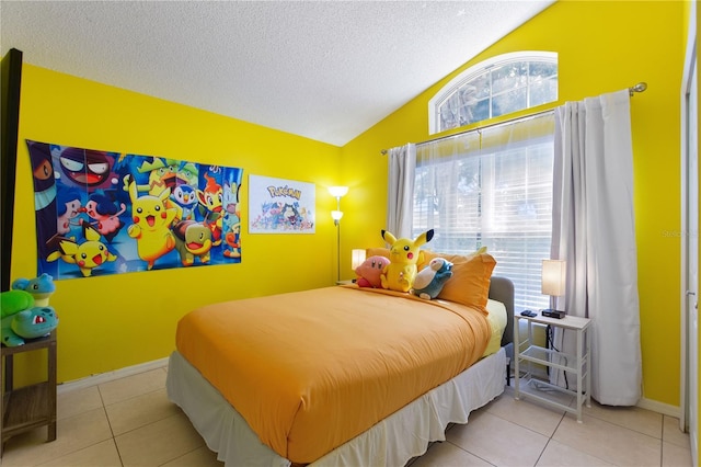 bedroom featuring lofted ceiling, a textured ceiling, baseboards, and light tile patterned floors