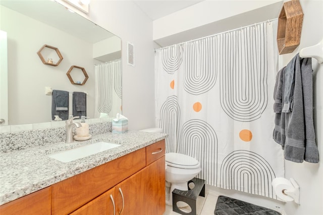 bathroom with visible vents, a shower with shower curtain, toilet, tile patterned floors, and vanity