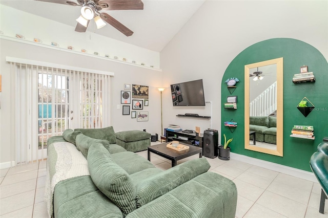 living room featuring baseboards, high vaulted ceiling, a ceiling fan, and tile patterned floors