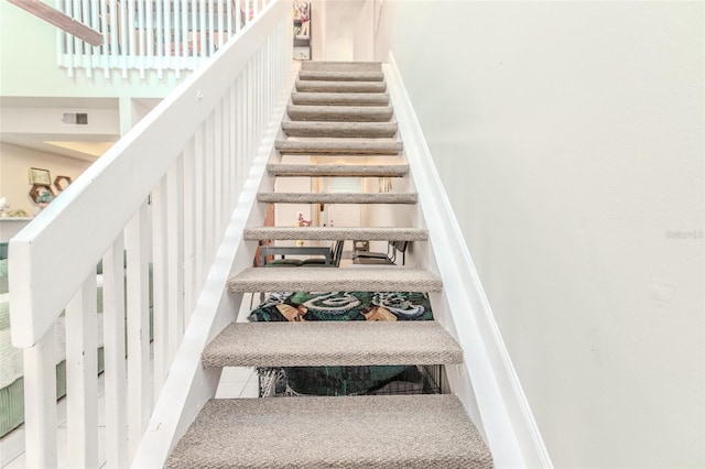 stairway with visible vents and tile patterned floors