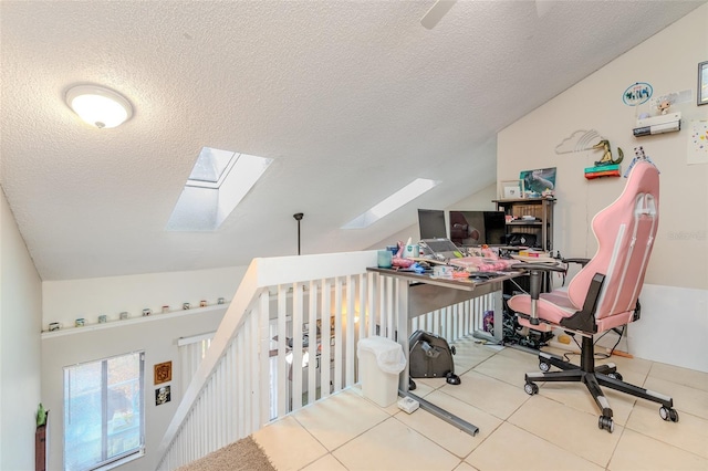 tiled office with a textured ceiling and lofted ceiling with skylight