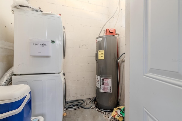 utility room featuring water heater and stacked washing maching and dryer