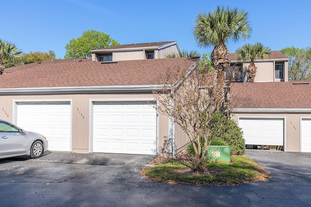 single story home with community garages and roof with shingles