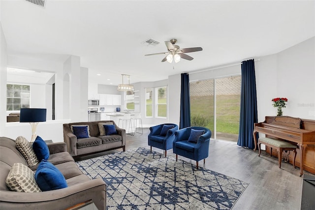 living area featuring recessed lighting, light wood-type flooring, visible vents, and a ceiling fan