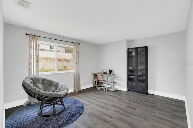 sitting room featuring wood finished floors, visible vents, and baseboards