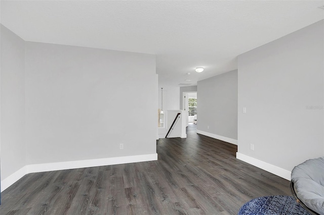 interior space featuring baseboards and wood finished floors