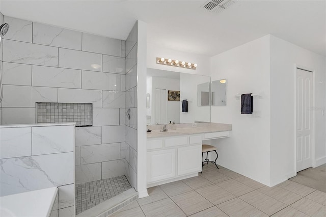 full bath with visible vents, a walk in shower, and vanity