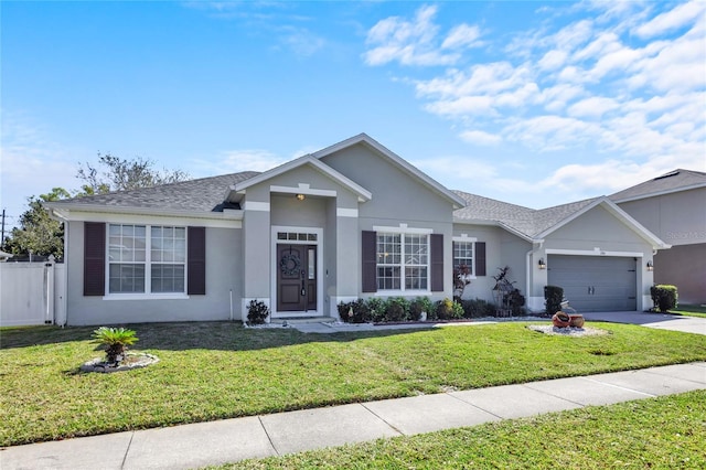 ranch-style house featuring a garage, fence, concrete driveway, stucco siding, and a front yard