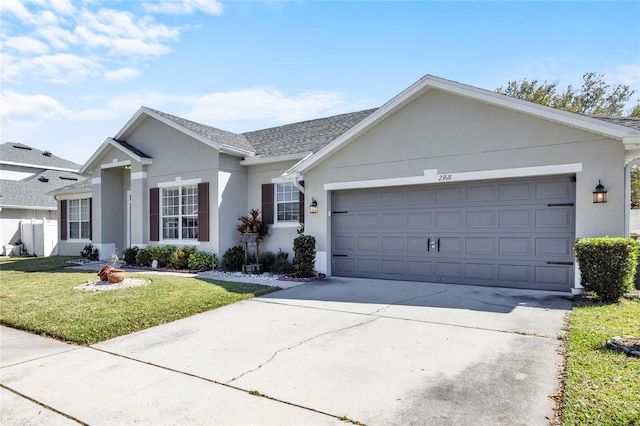 ranch-style house featuring driveway, a shingled roof, stucco siding, an attached garage, and a front yard