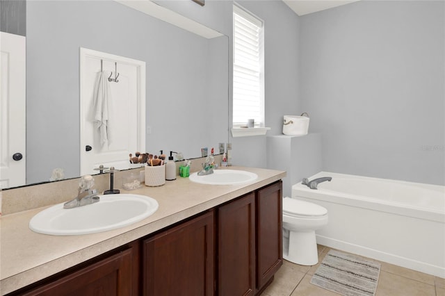 full bathroom featuring a garden tub, double vanity, a sink, and tile patterned floors