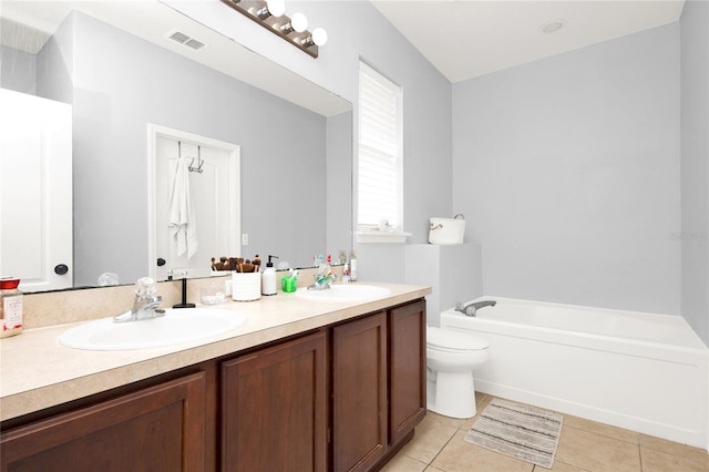 bathroom with a bath, tile patterned flooring, double vanity, and a sink