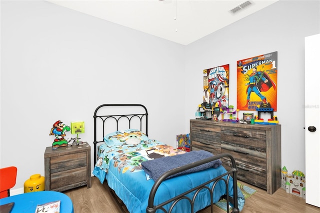 bedroom featuring visible vents and wood finished floors