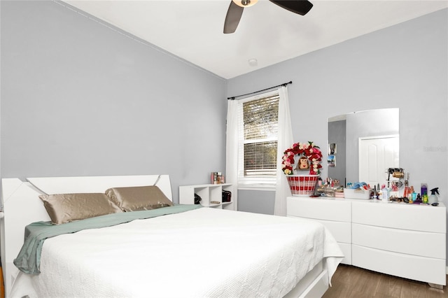 bedroom with a ceiling fan and wood finished floors