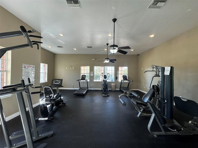 workout area with visible vents, a textured ceiling, and baseboards