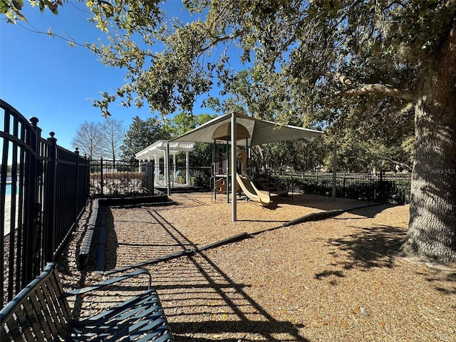 view of yard with playground community and fence