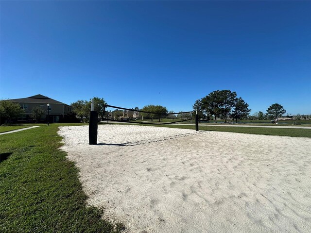 view of home's community with a yard and volleyball court