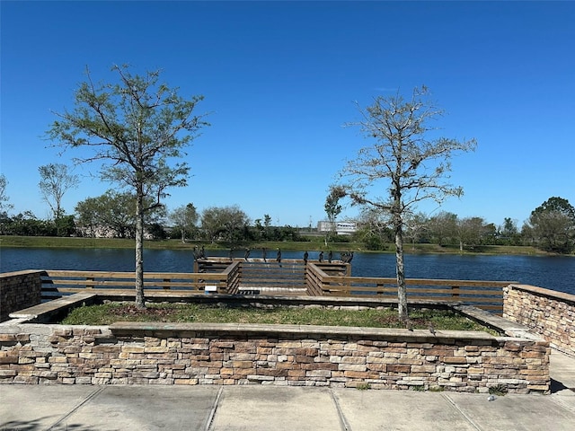 exterior space featuring a dock and a water view