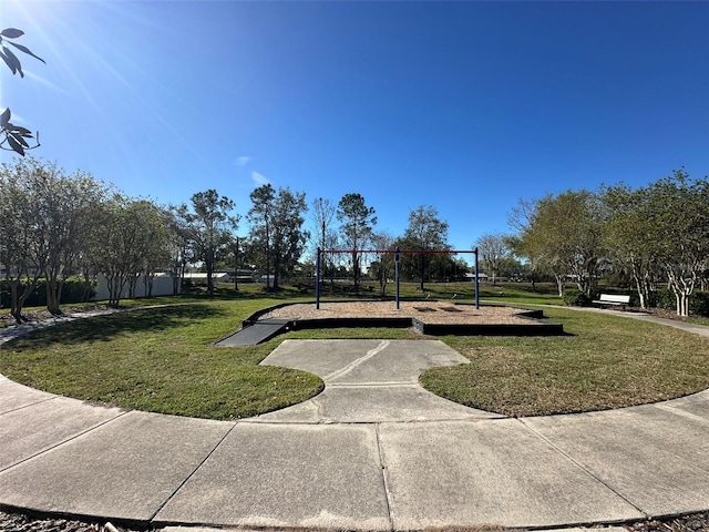 view of property's community featuring playground community and a lawn