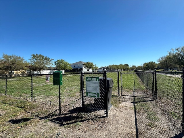 view of gate featuring a yard and fence