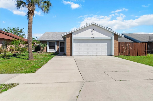 view of front facade with brick siding, concrete driveway, an attached garage, fence, and a front lawn