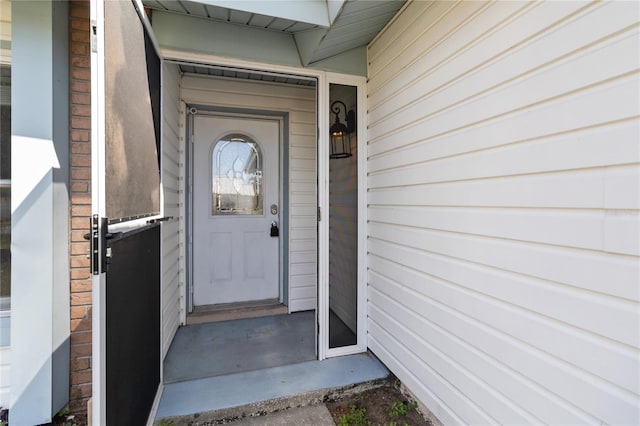 view of exterior entry featuring brick siding