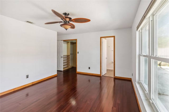 unfurnished bedroom featuring baseboards, visible vents, ceiling fan, wood finished floors, and a closet