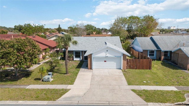 single story home featuring a shingled roof, a front yard, fence, a garage, and driveway