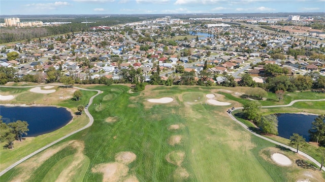 birds eye view of property featuring a residential view, view of golf course, and a water view