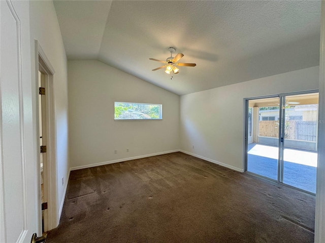 empty room featuring lofted ceiling, a healthy amount of sunlight, ceiling fan, and carpet