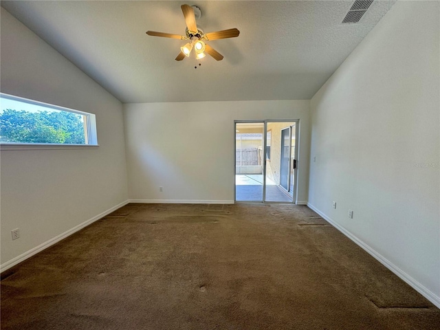 unfurnished room with lofted ceiling, a healthy amount of sunlight, carpet, and visible vents