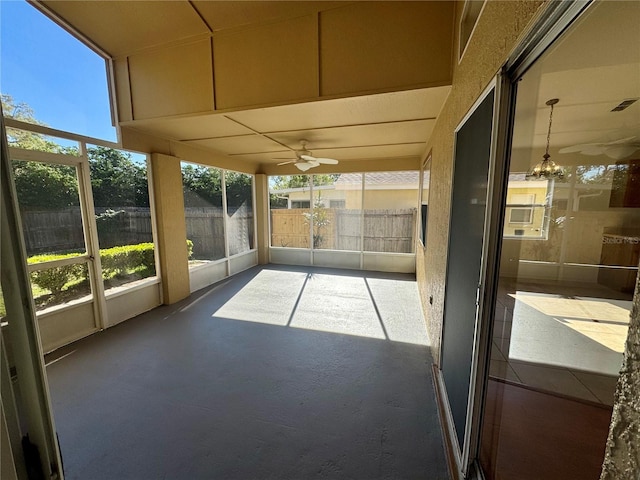 unfurnished sunroom with ceiling fan