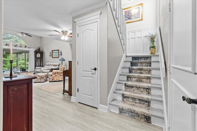 stairs with ceiling fan and wood finished floors