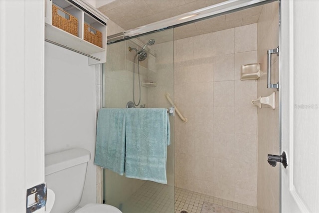 full bathroom with toilet and a stall shower