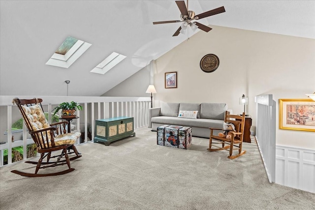 living room featuring carpet floors, lofted ceiling with skylight, and ceiling fan