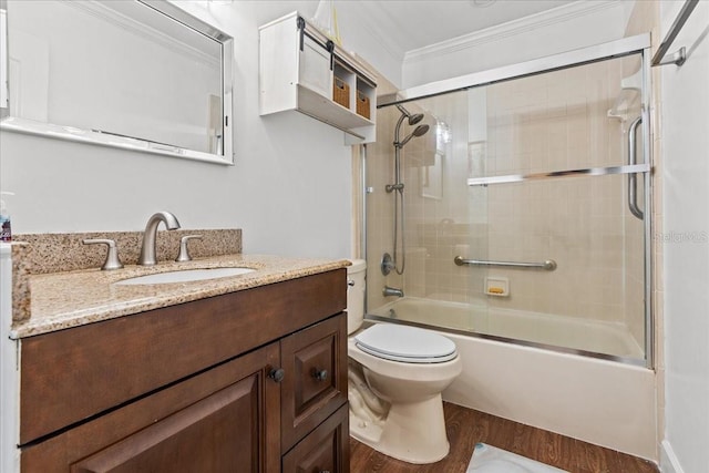 full bathroom featuring toilet, shower / bath combination with glass door, ornamental molding, wood finished floors, and vanity