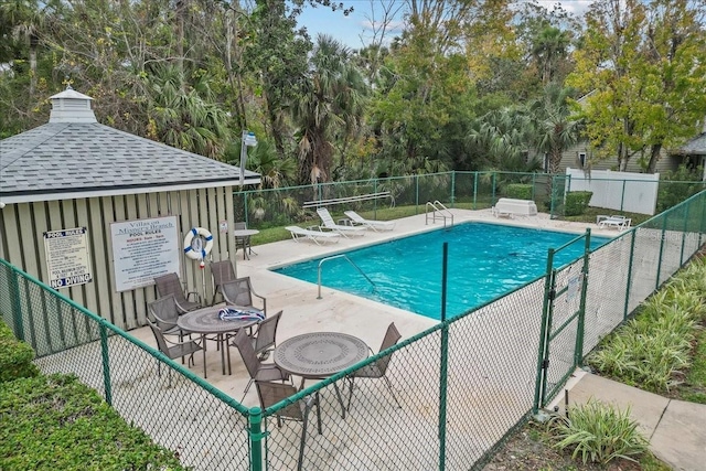 pool featuring a patio area and fence