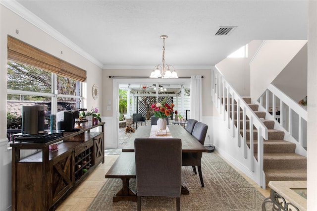 dining area with crown molding, visible vents, a notable chandelier, and stairs