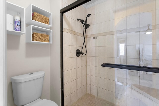 full bath with crown molding, a shower stall, and toilet