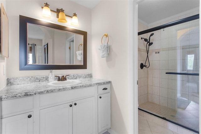 bathroom with ornamental molding, a stall shower, and vanity