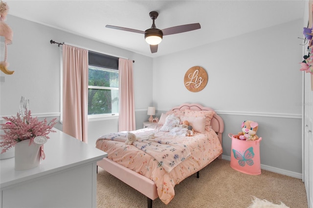 carpeted bedroom with a ceiling fan and baseboards