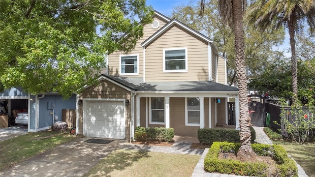 traditional-style house with driveway, a garage, and fence